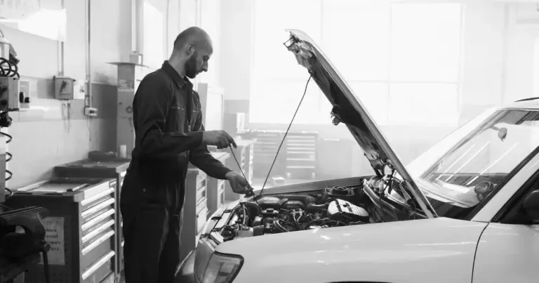 Mecânico verificando o óleo do motor com vareta